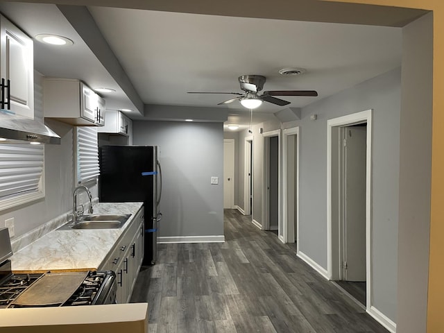 kitchen featuring stainless steel fridge, range with gas cooktop, sink, dark hardwood / wood-style floors, and white cabinetry