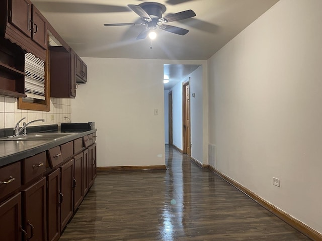 kitchen with dark brown cabinetry, ceiling fan, sink, dark wood-type flooring, and backsplash