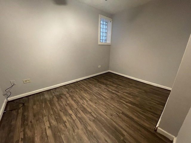 unfurnished room with dark hardwood / wood-style flooring