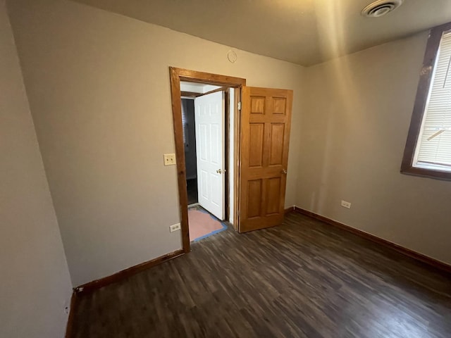 empty room featuring dark wood-type flooring