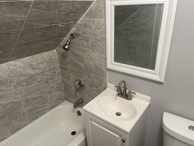 full bathroom with vanity, toilet, and tiled shower / bath