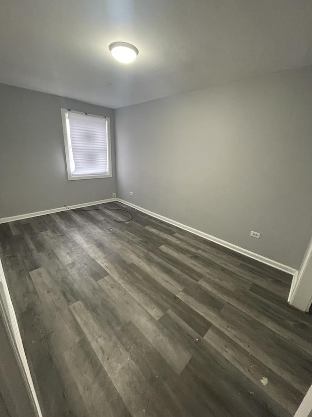 spare room featuring dark wood-type flooring