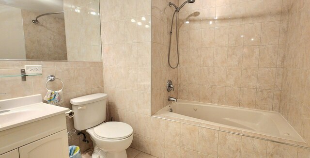 full bathroom with vanity, tiled shower / bath combo, tile walls, and toilet