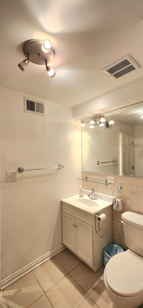 bathroom with tile patterned flooring, vanity, and toilet