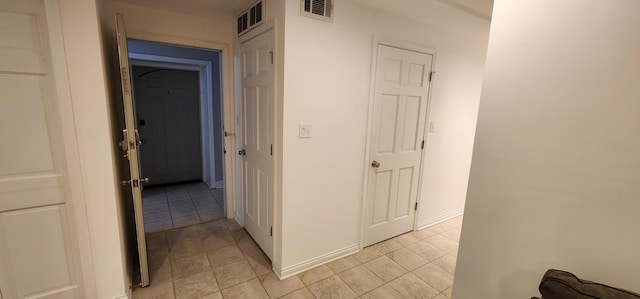 corridor with light tile patterned floors