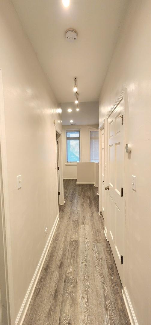 hallway featuring dark wood-type flooring