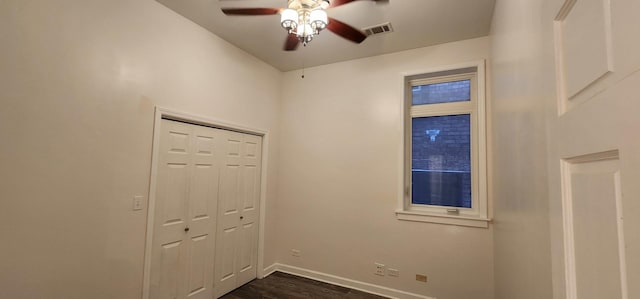 interior space featuring ceiling fan and dark wood-type flooring