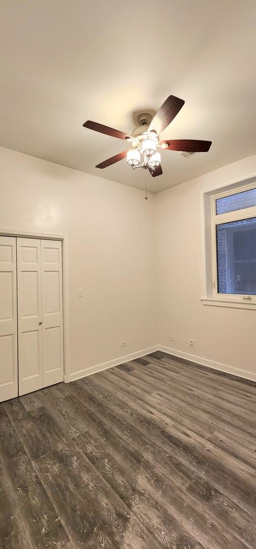 unfurnished room featuring dark wood-type flooring