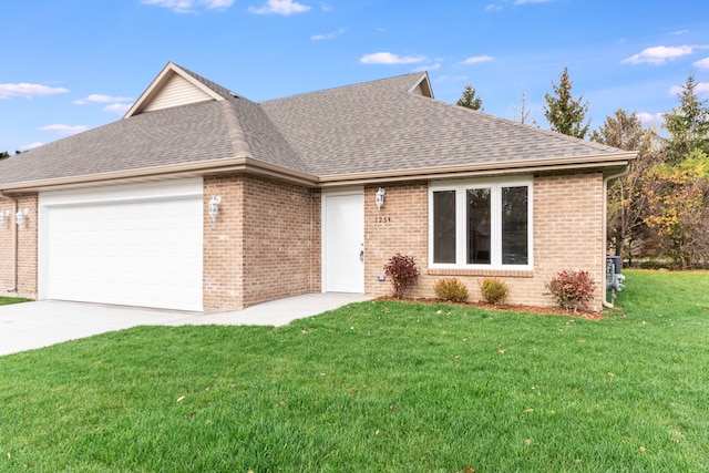 single story home featuring a garage and a front lawn