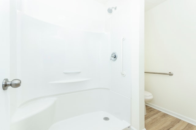 bathroom featuring hardwood / wood-style flooring and toilet