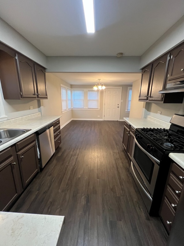 kitchen with dark wood-type flooring, sink, appliances with stainless steel finishes, and dark brown cabinets