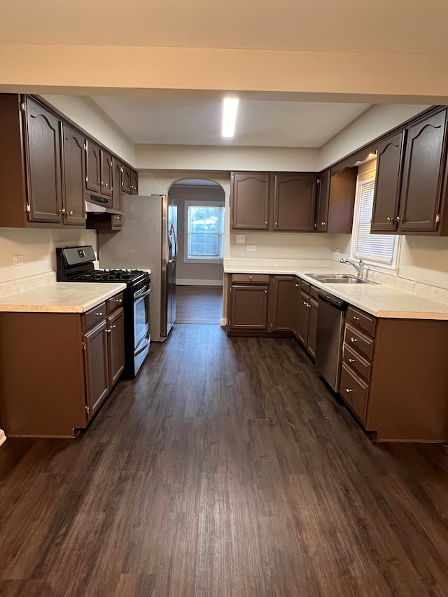 kitchen featuring sink, dark brown cabinetry, dark hardwood / wood-style floors, and appliances with stainless steel finishes