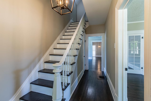 1011 5th St, Mendota, IL 61342 - stairs with wood finished floors, a chandelier, and baseboards
