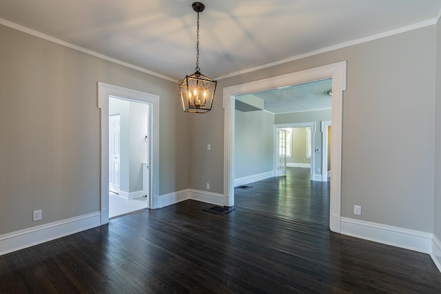 1011 5th St, Mendota, IL 61342 - spare room with dark wood-style flooring, a chandelier, baseboards, and crown molding
