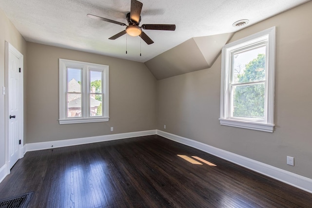 1011 5th St, Mendota, IL 61342 - bonus room with dark wood-type flooring, ceiling fan, a textured ceiling, baseboards, and vaulted ceiling