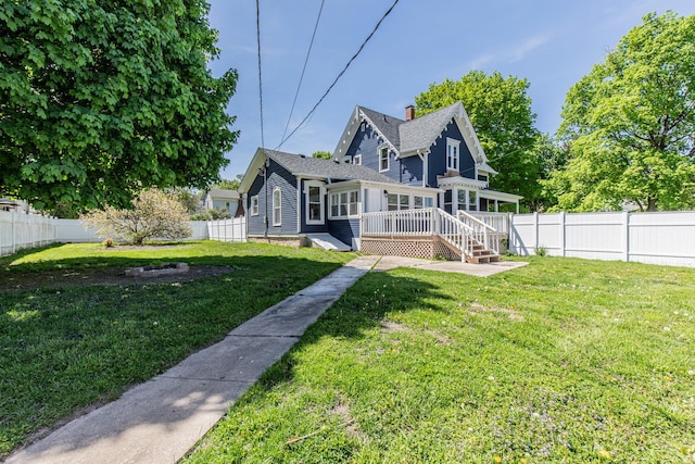 1011 5th St, Mendota, IL 61342 - back of property featuring a wooden deck and a chimney