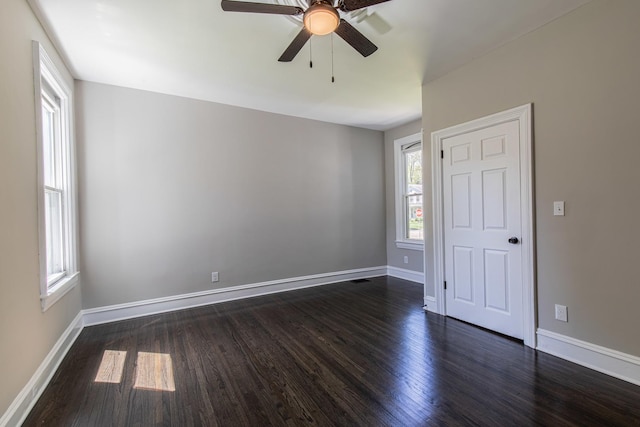 1011 5th St, Mendota, IL 61342 - spare room featuring a ceiling fan, dark wood-style floors, and baseboards