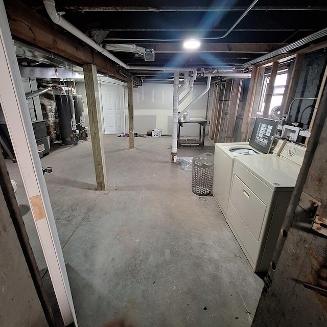 basement with washing machine and clothes dryer and gas water heater