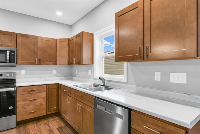 kitchen with sink, stainless steel appliances, and dark hardwood / wood-style floors