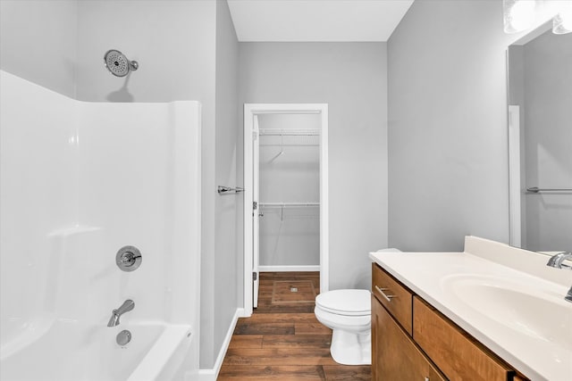 full bathroom with wood-type flooring, vanity, toilet, and tub / shower combination