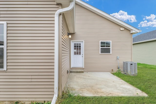 rear view of property with cooling unit and a patio area