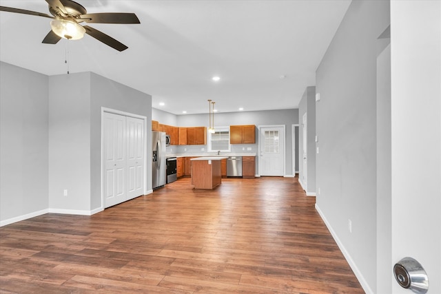 unfurnished living room with wood-type flooring and ceiling fan