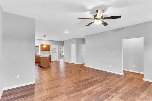 unfurnished living room with light hardwood / wood-style floors and ceiling fan