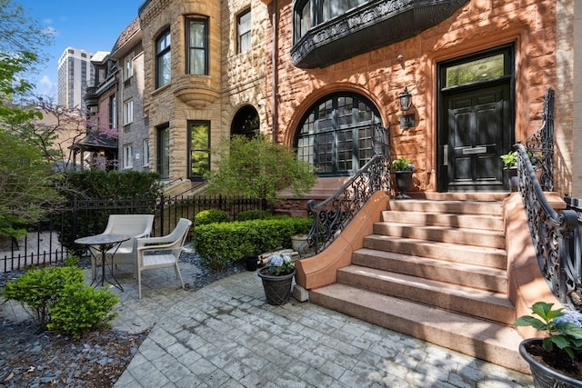 view of exterior entry with a patio