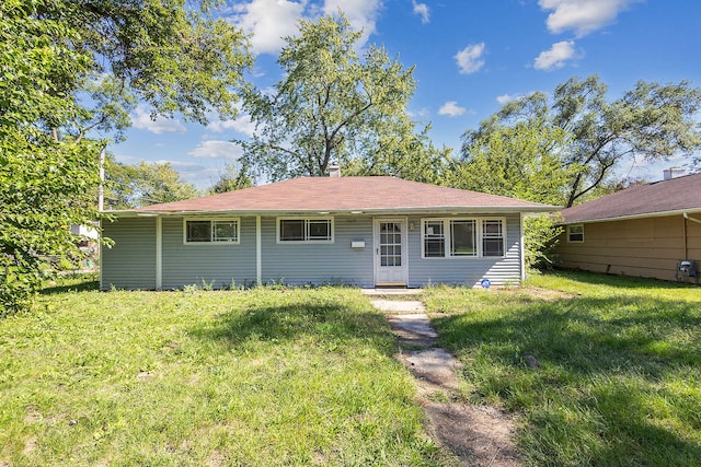 rear view of house with a yard