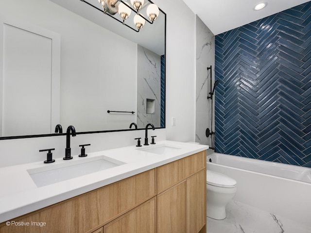 full bathroom with tile floors, large vanity, dual sinks, toilet, and tiled shower / bath