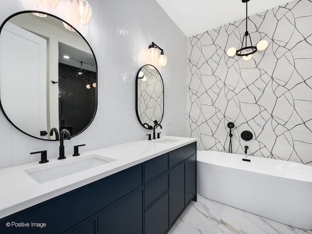 bathroom with tile walls, dual bowl vanity, tile flooring, and a tub