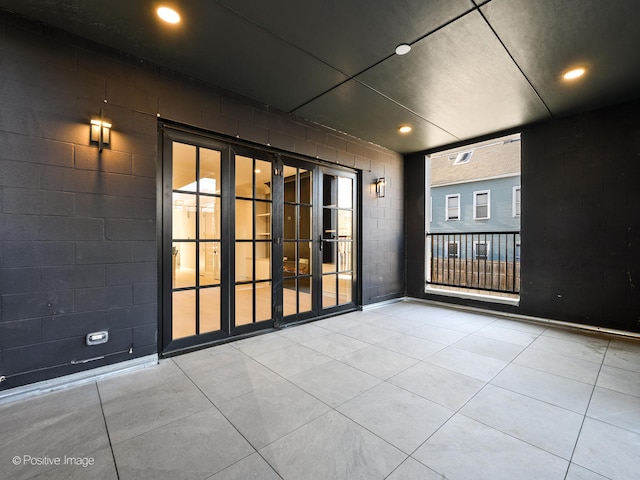 empty room with plenty of natural light and light tile floors