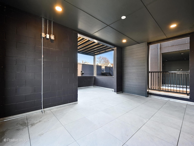 unfurnished room featuring light tile floors and a paneled ceiling