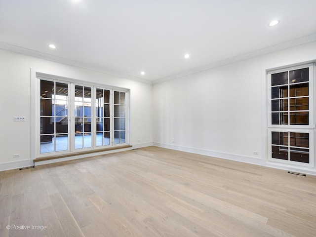 unfurnished room with ornamental molding and light hardwood / wood-style floors