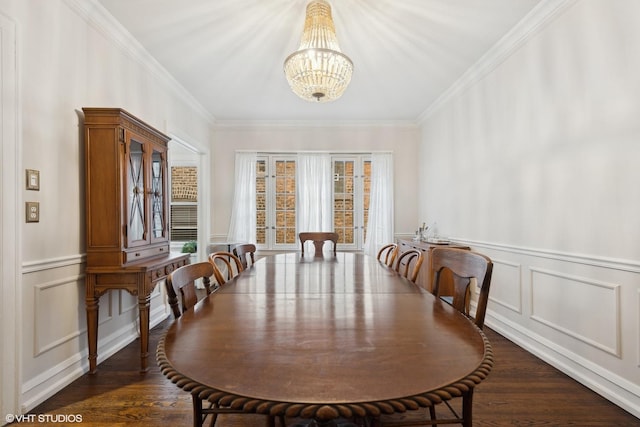 dining area featuring dark hardwood / wood-style flooring, crown molding, and a chandelier