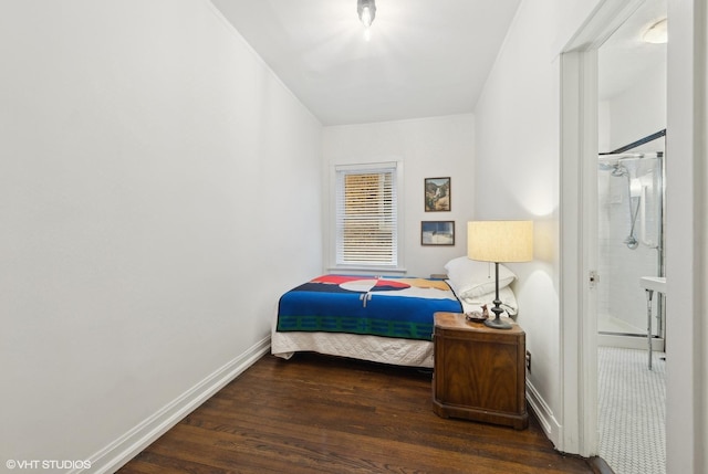 bedroom with ensuite bathroom and dark hardwood / wood-style flooring