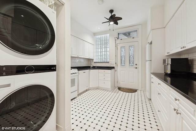 laundry room featuring ceiling fan and stacked washing maching and dryer