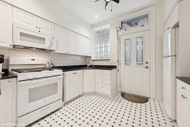 kitchen with white cabinetry, white appliances, ceiling fan, and backsplash