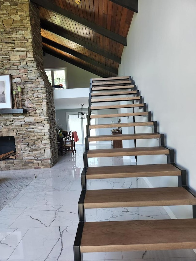 36W461 Binnie Rd, Dundee, IL 60118 - stairs with wooden ceiling, an inviting chandelier, a stone fireplace, light tile floors, and high vaulted ceiling