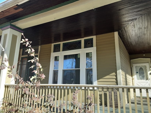 view of exterior entry featuring a porch