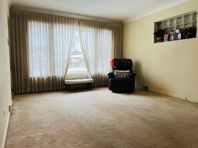 unfurnished room featuring crown molding and light colored carpet