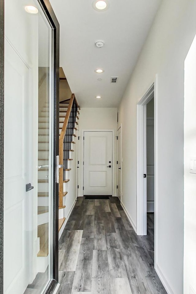 corridor with dark hardwood / wood-style flooring