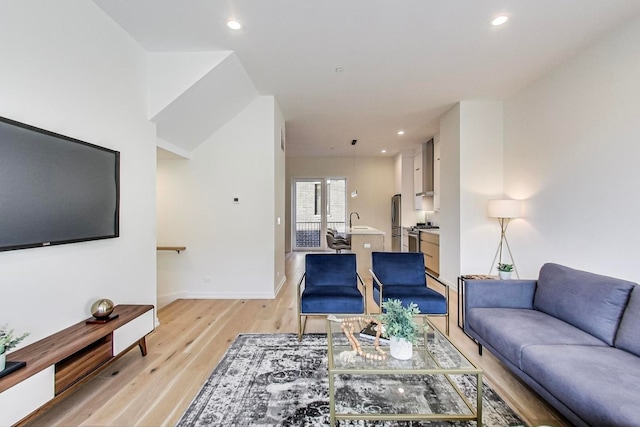 living room featuring light hardwood / wood-style floors and sink