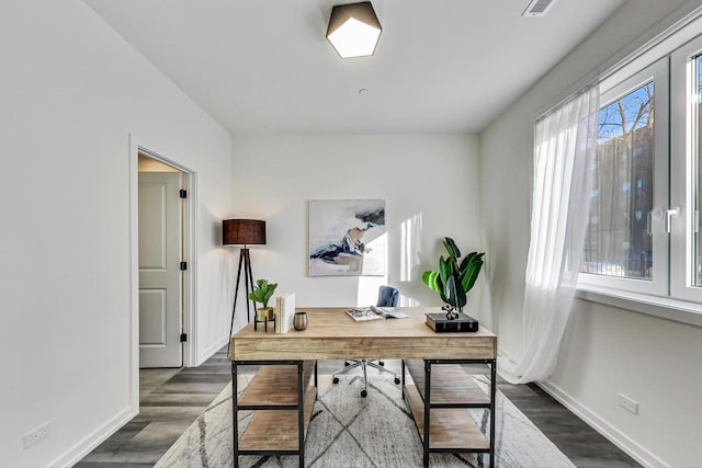 office space with dark wood-type flooring