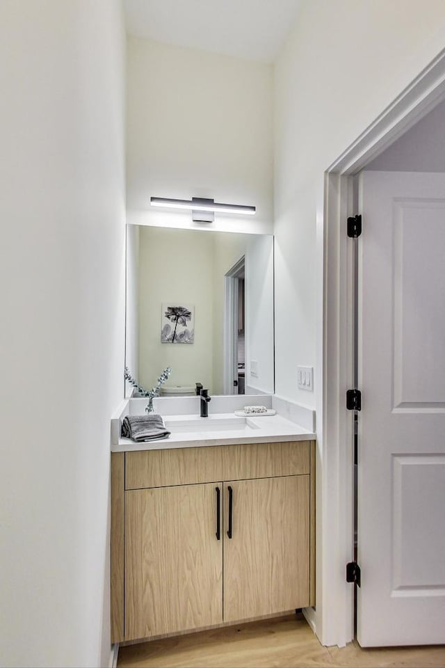 bathroom featuring hardwood / wood-style floors and vanity