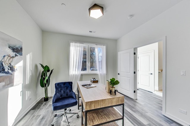 office area with light hardwood / wood-style floors