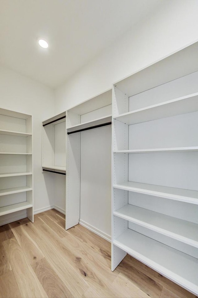 spacious closet featuring light wood-type flooring