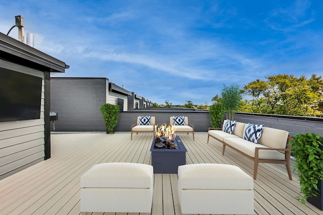 wooden deck with an outdoor living space with a fire pit