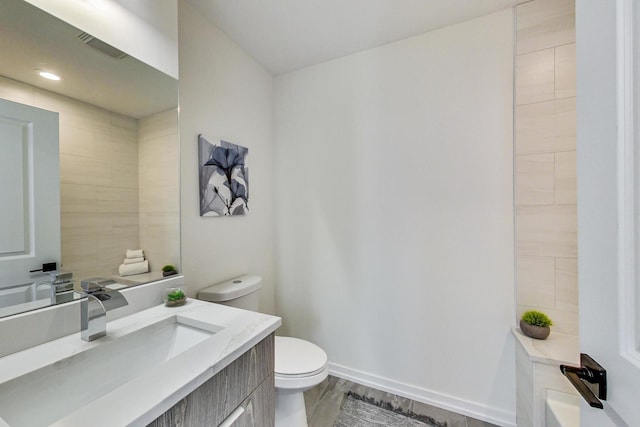 bathroom featuring hardwood / wood-style floors, large vanity, and toilet