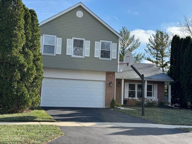 view of front of house featuring a front lawn, brick siding, an attached garage, and driveway